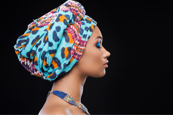 A beautiful woman with a colorful headscarf and make-up, thinking about what it means to love yourself