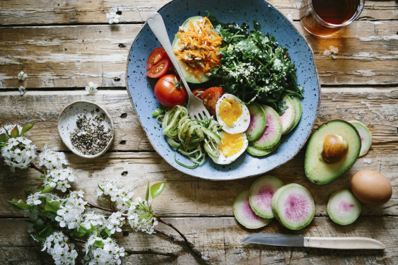 Avocado vegetable egg salad on wooden table