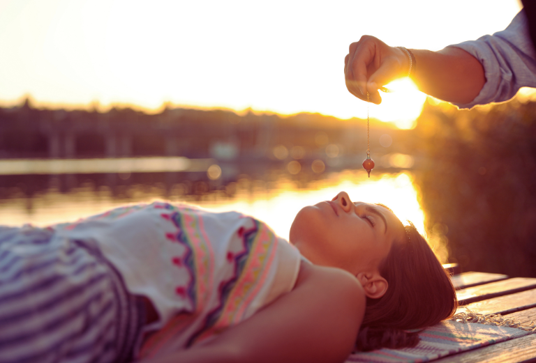 Woman doing crystal meditation outdoors