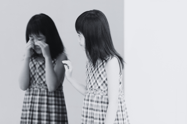 The girl is trying to comfort and appease her inner child