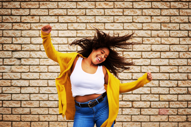 Young woman is dancing happily
