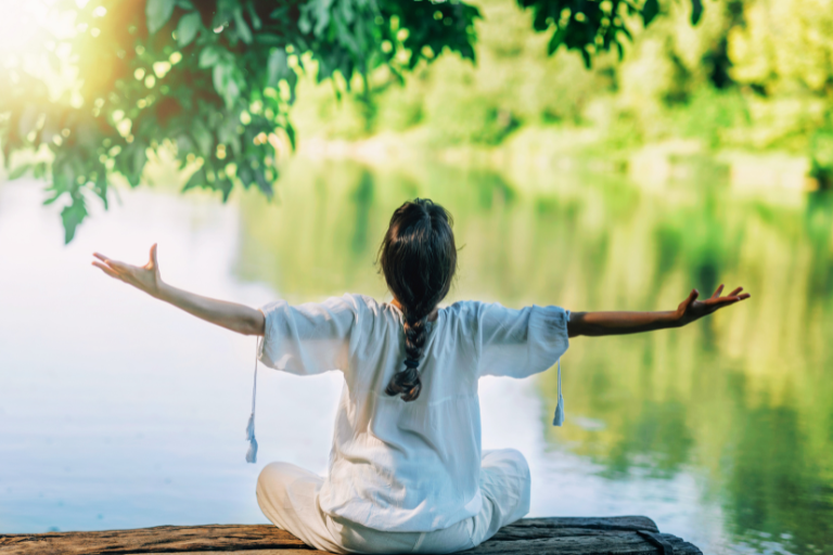 Practice mindfulness and self-reflection of a woman by the river