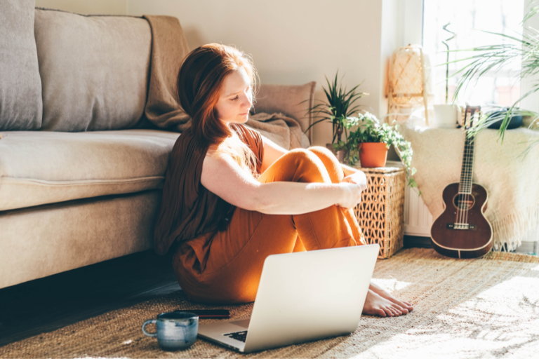 A teenage girl sitting on the floor doesn't understand what Self-Doubt is