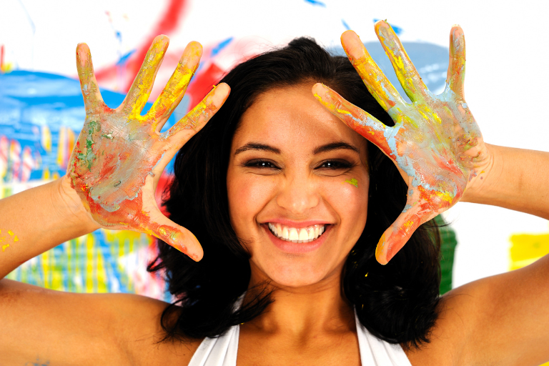 The woman is enjoying the joy of painting, helping her inner child find peace and healing.